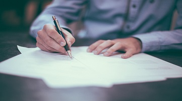 man signing papers third party risk management